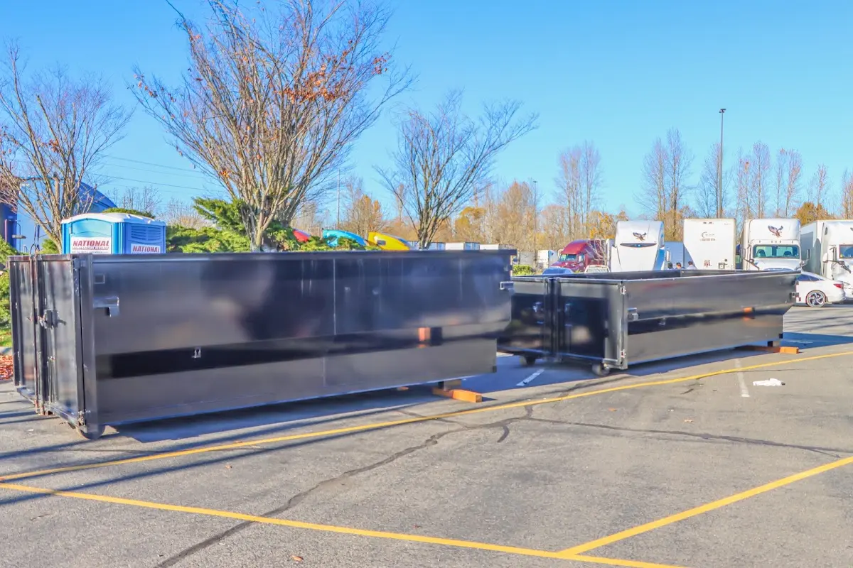 Professional dumpster rental service with roll-off container on residential driveway in Oyster Bay